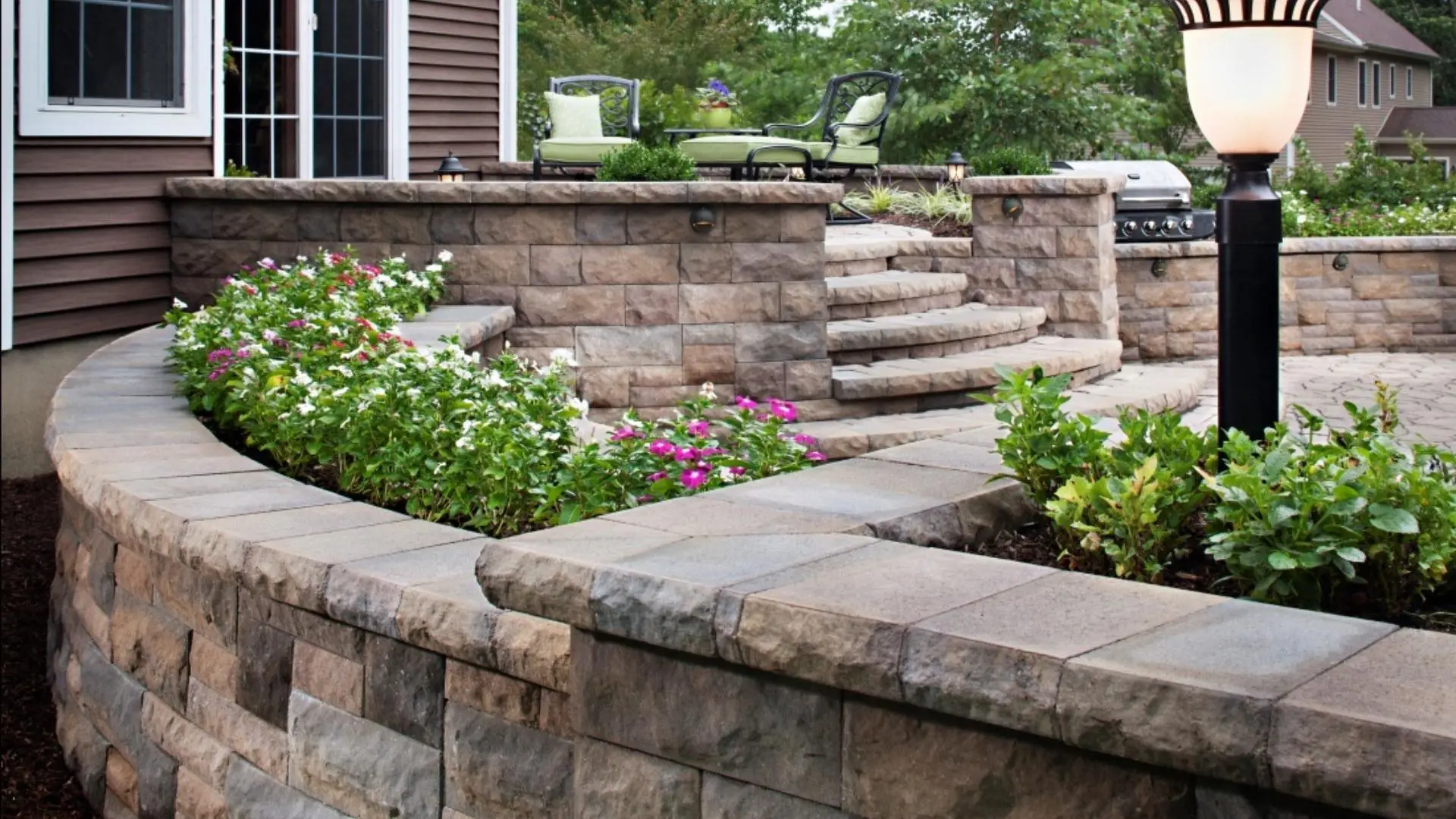 Retaining wall with landscape bed installed in Des Moines, IA.