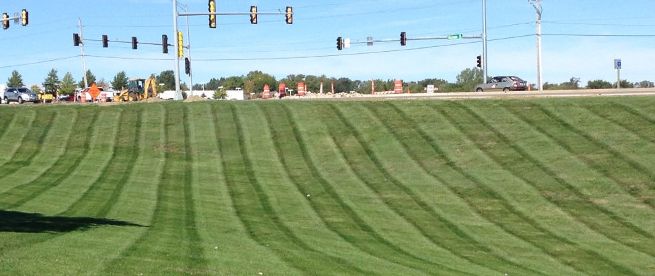 Commercial property with mowed lawn with stripe patterns in Urbandale, IA.