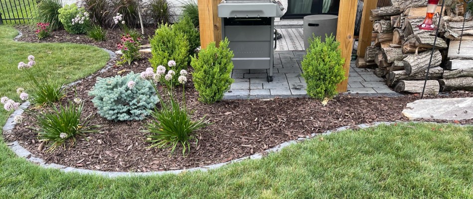 Landscape bed installed with mulch ground covering in Des Moines, IA.