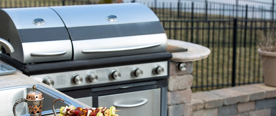 Outdoor kitchen installed with a grill and sink in Urbandale, IA.