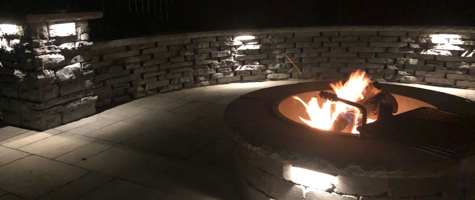 Outdoor lighting installed for seating area around fire pit in Ankeny, IA.