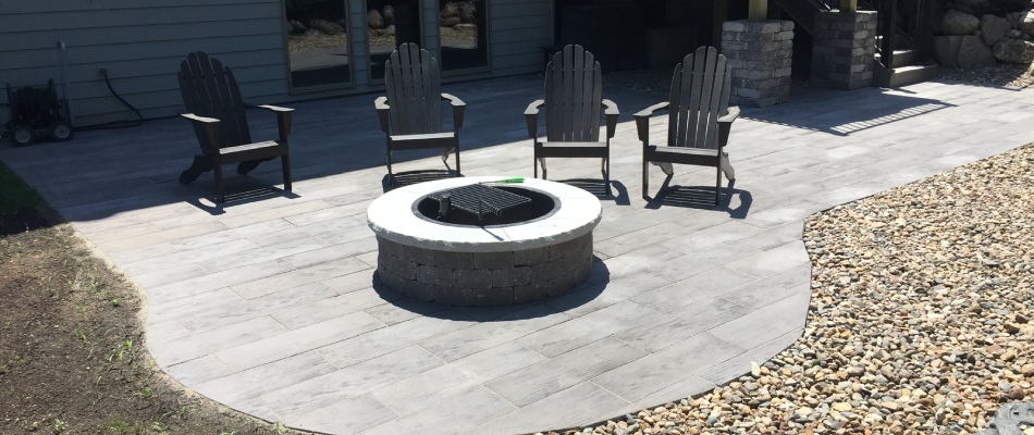 Custom fire pit built over custom patio installed in Des Moines, IA.