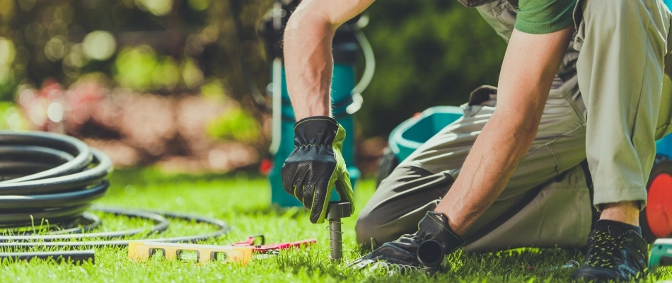 Professional installing an irrigation system in Urbandale, IA.