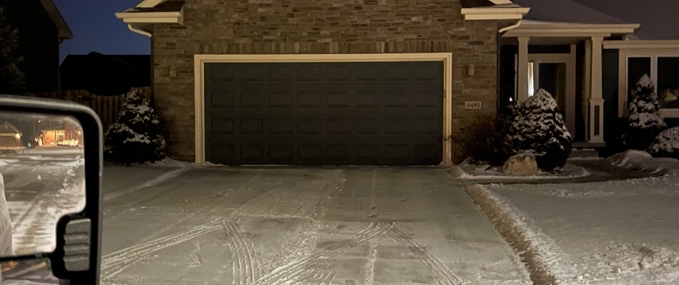 Driveway being plowed before homeowners need access in Grimes, IA.