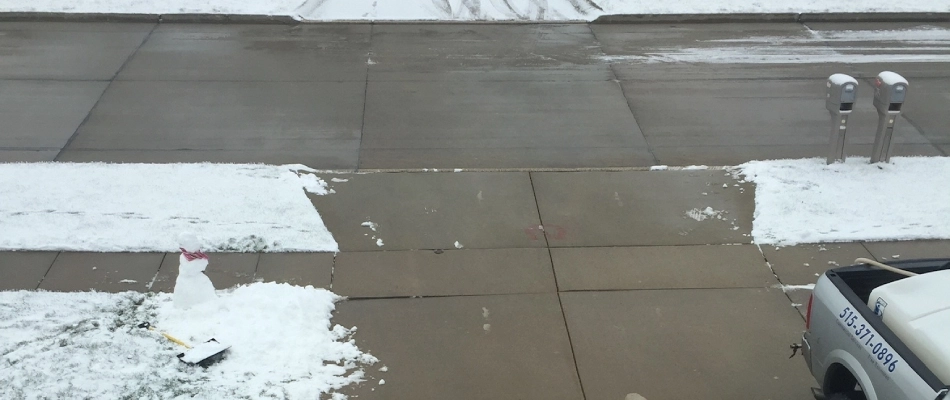 Driveway of home cleared out from snow plow in Urbandale, IA.