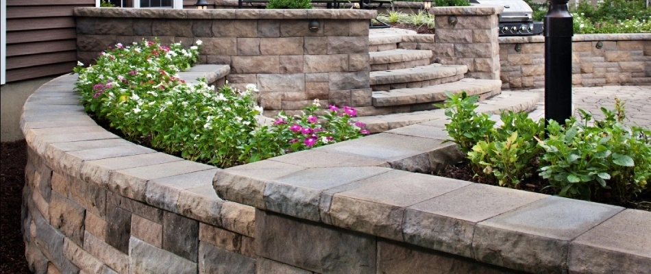 Retaining wall built with landscape beds installed in Ankeny, IA.