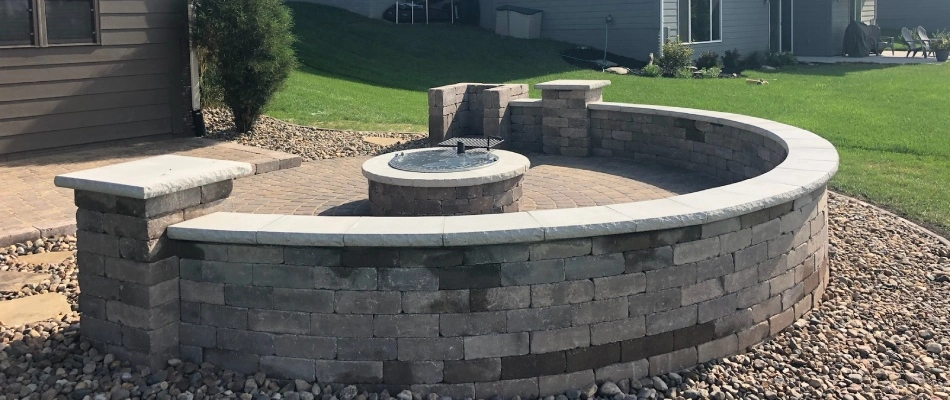 Retaining wall and seating wall for fire pit area in Waukee, IA.