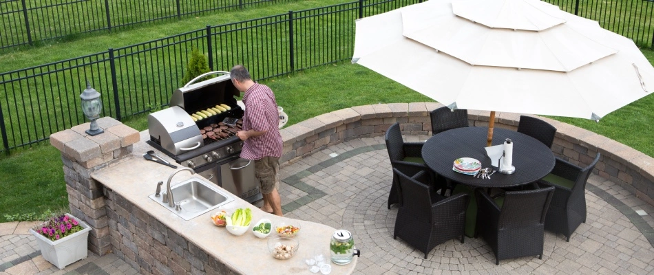 Seating wall installed with outdoor kitchen in Urbandale, IA.