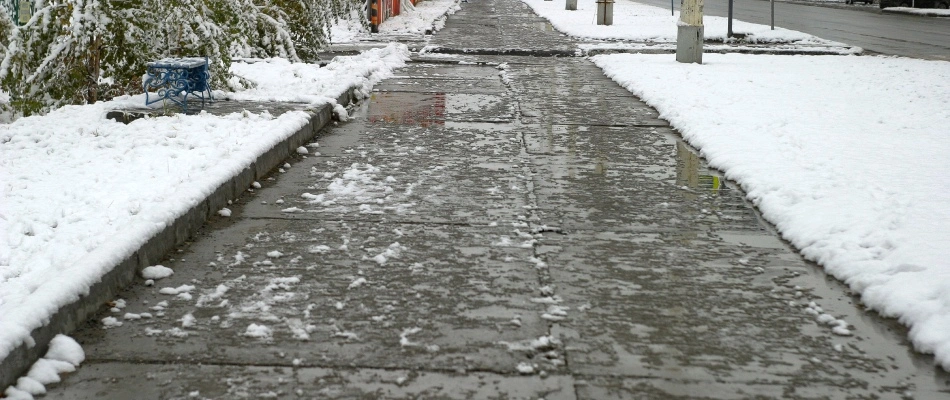 Sidewalk cleared from snow and ice from removal services in Des Moines, IA.